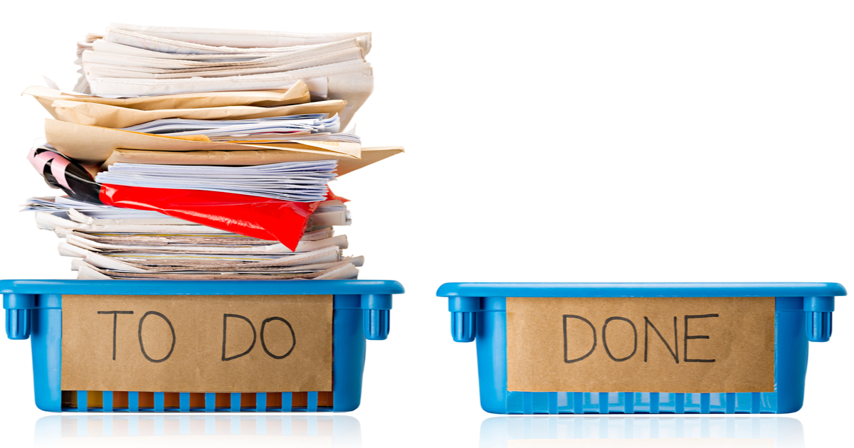 Procrastination-A full To Do tray and an empty one isolated on a white background.